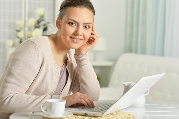 Portrait of young beautiful woman using laptop