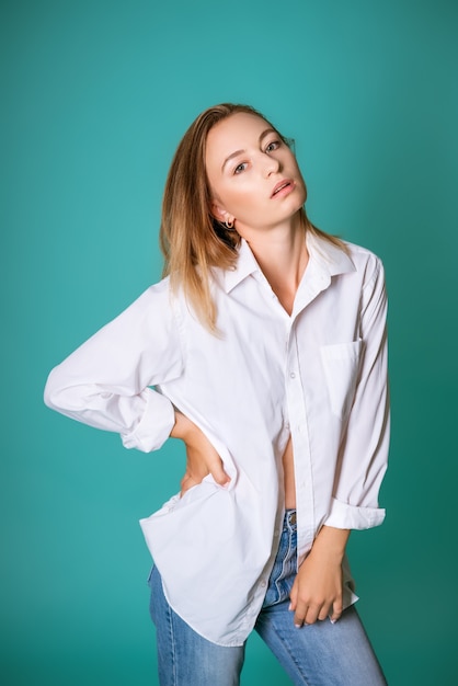 Portrait of a young beautiful woman in a white shirt isolated