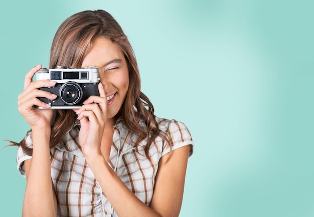 Portrait of young beautiful woman with camera