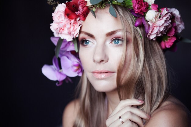 Portrait  young beautiful woman in wreath of flowers