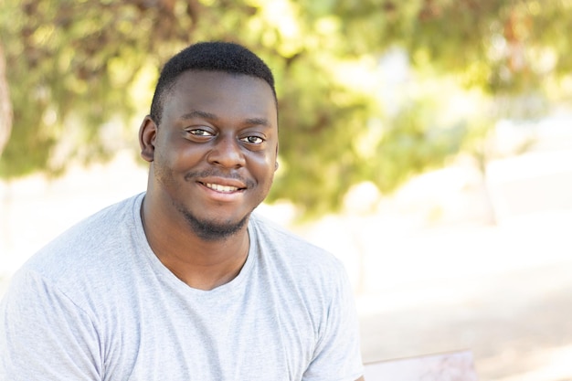 Portrait of a young black male in a sunny park