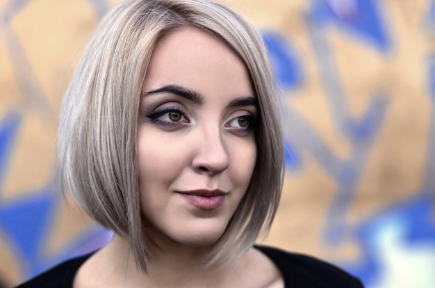 Portrait of a young blond girl with short hair 