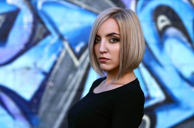 Portrait of a young blond girl with short hair 