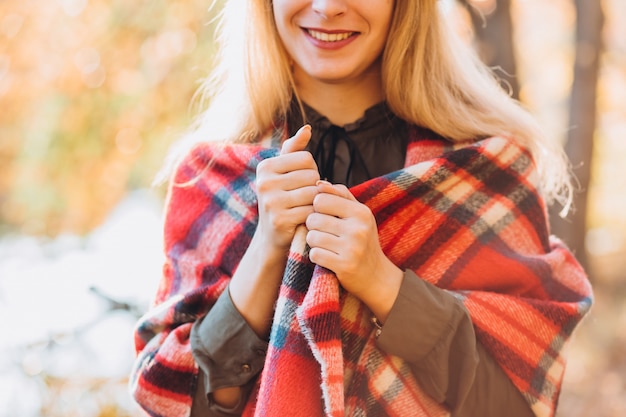 Portrait of a young blonde woman in the autumn forest