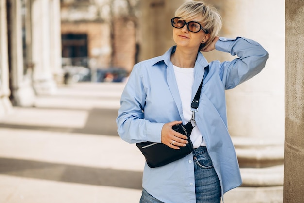 Portrait of young blonde woman posing in the street