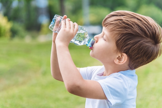 portrait young boy drinking water