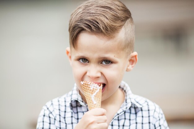 Portrait of young boy eating ice cream outdoors