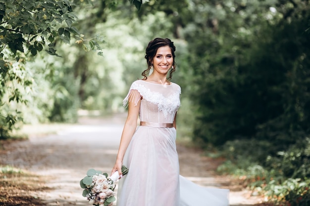 Portrait of a young bride posing in nature