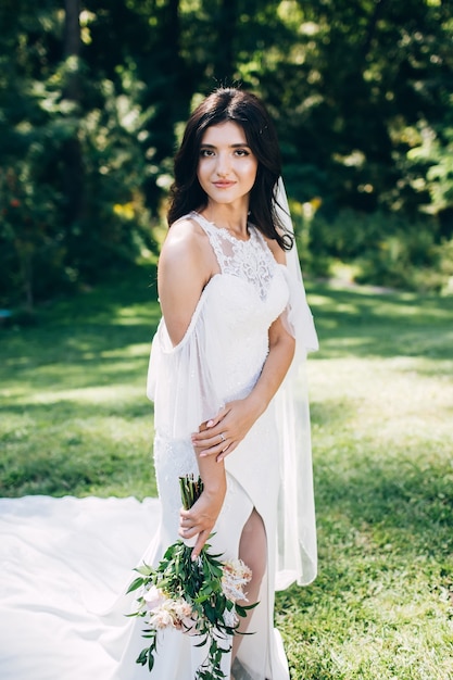 Portrait of a young bride posing in nature