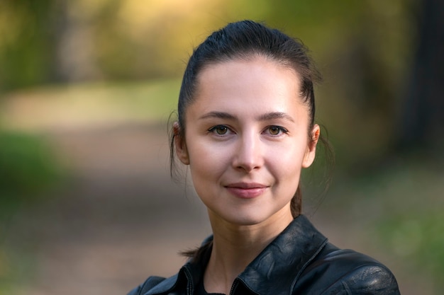 Portrait of a young brunette girl outdoors