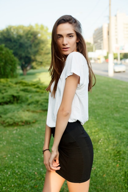 Portrait of a young brunette girl in a white T-shirt