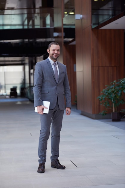 portrait of young business man with tablet computer at modern office