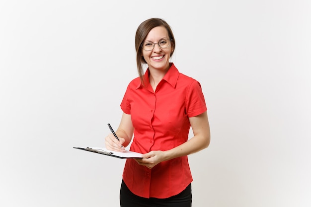 Portrait of young business teacher woman in red shirt, glasses holding pen clipboard with blank empty paper documents isolated on white background. Education teaching in high school university concept