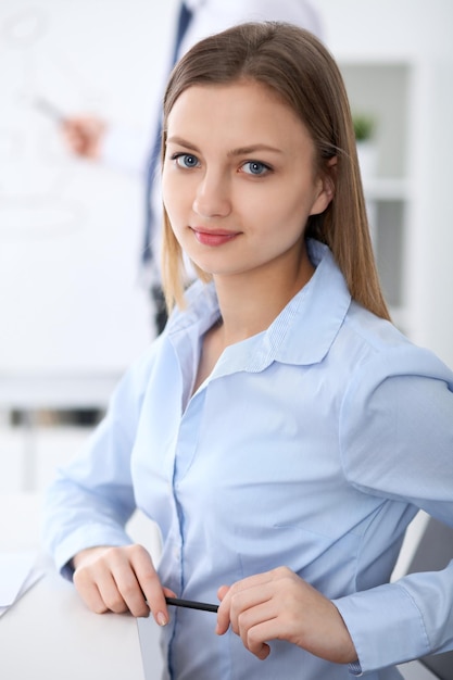 Portrait of a young business woman  at meeting.