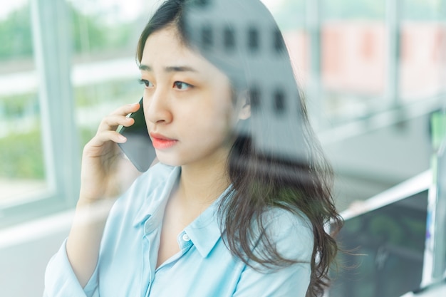 Portrait of young business woman talking on the phone