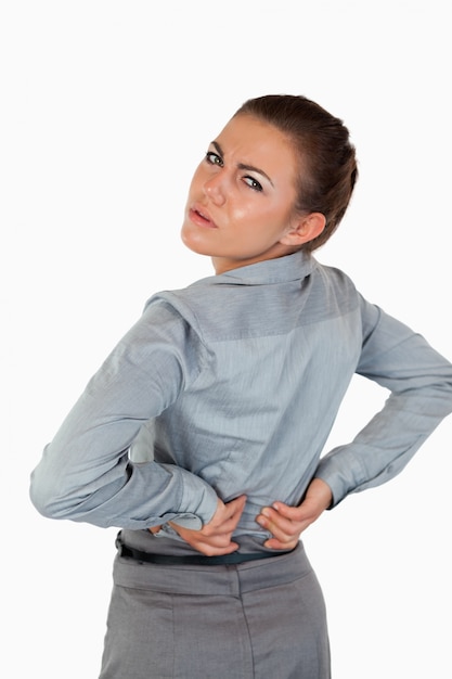 Portrait of a young businesswoman having back pain