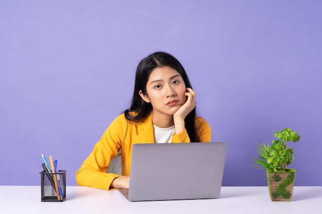 Portrait of young businesswoman on purple background