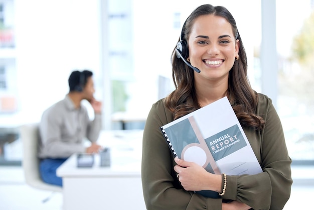 Portrait of a young businesswoman using a headset in a modern office