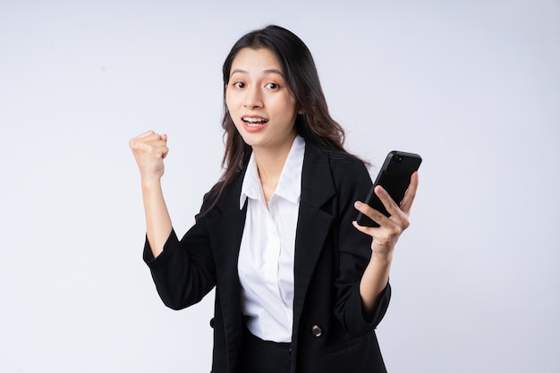 Portrait of young businesswoman wearing a suit, isolated on white background