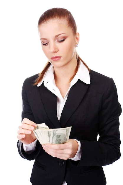 Portrait of young businesswoman with pile of money