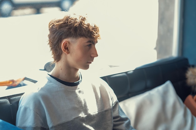 Portrait of a young Caucasian boy with a fresh mullet haircut