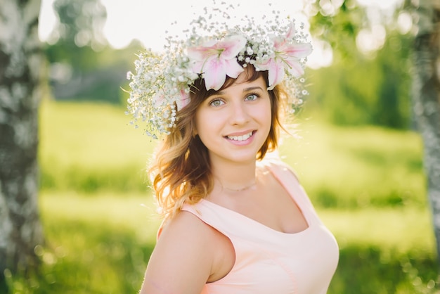 Portrait of a young Caucasian girl with a wreath of flowers on her head