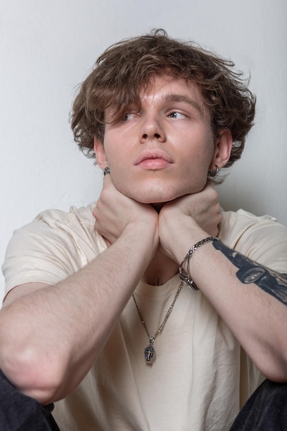 Portrait of a young caucasian man leaning on his hands