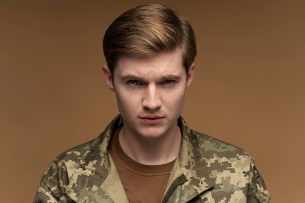 Portrait of young caucasian military man wearing army uniform depressed