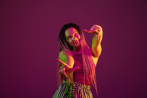 Portrait of young caucasian woman on pink background