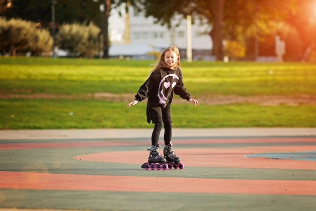 Portrait of young child or teen girl roller skating outdoors fitness well being active healthy lifestyle