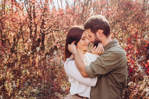 Portrait of a young couple in the autumn forest