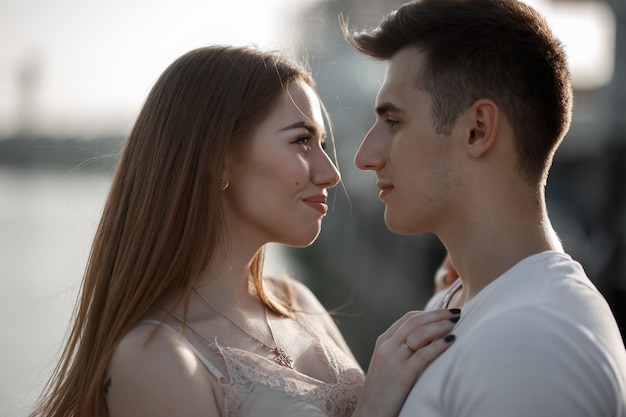 Portrait of young couple in love, enjoying the sunset in city.