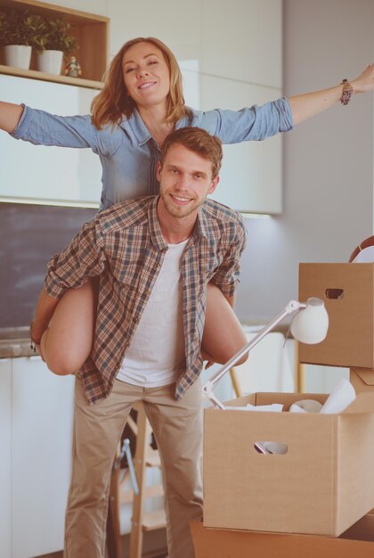 Portrait of young couple moving in new home Young couple