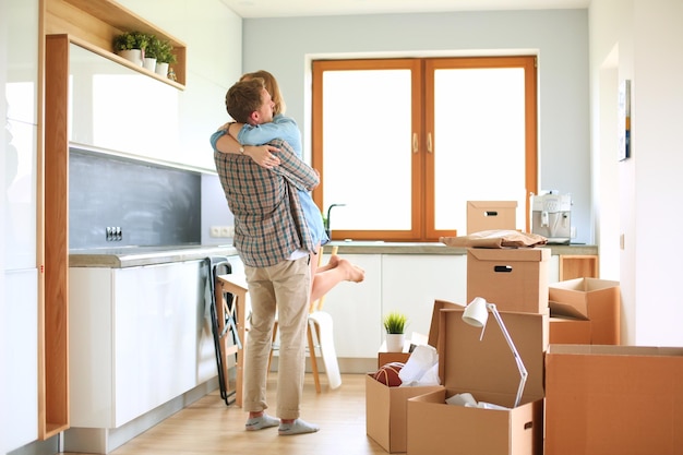 Portrait of young couple moving in new home Young couple