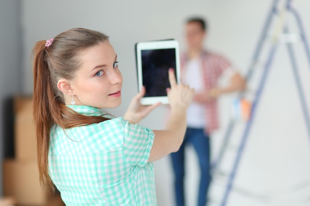 Portrait of young couple moving in new home Young couple