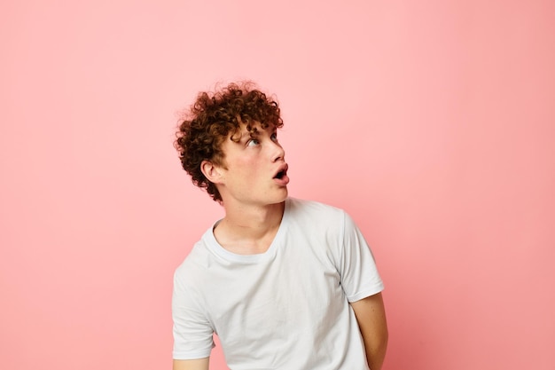 Portrait of a young curly man summer clothes white tshirt posing lifestyle unaltered