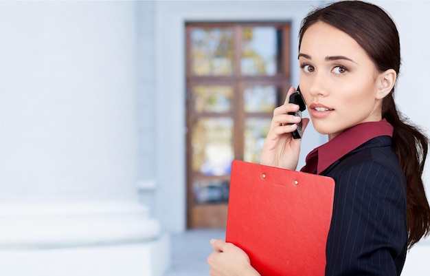 Portrait of young cute business woman on background