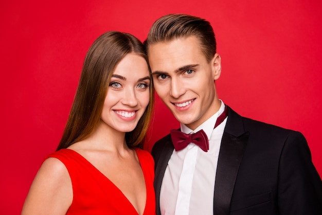 Portrait of young cute couple on a red background