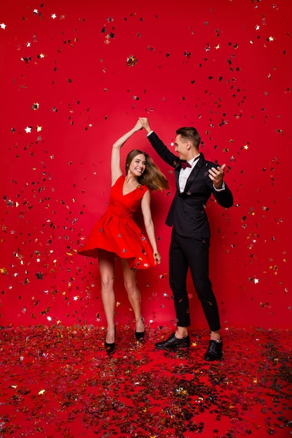 Portrait of young cute couple on a red background