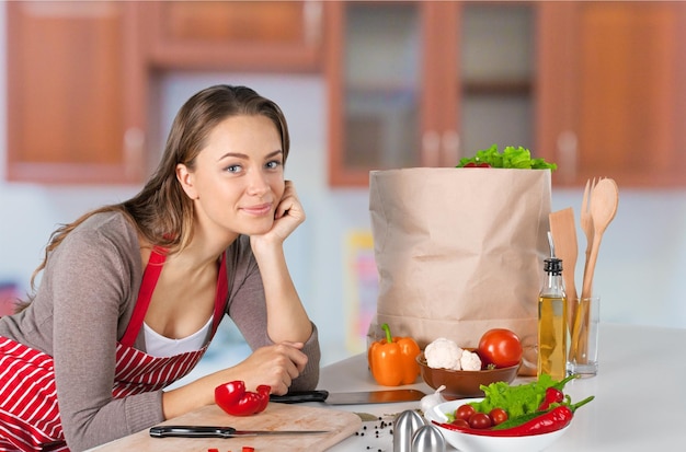 Portrait of young cute woman with food on background