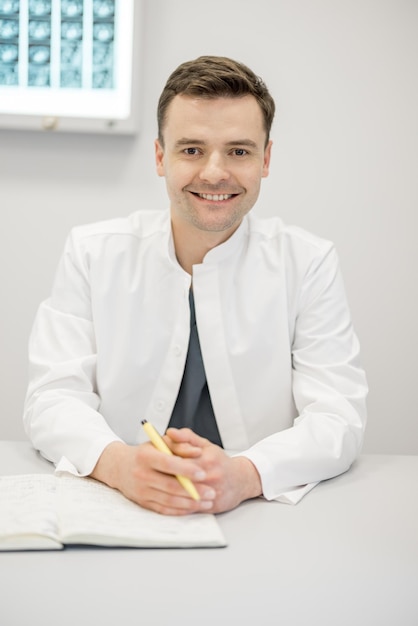 Portrait of young doctor at clinic