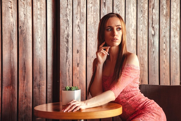 Portrait of young elegant blonde woman posing outdoors