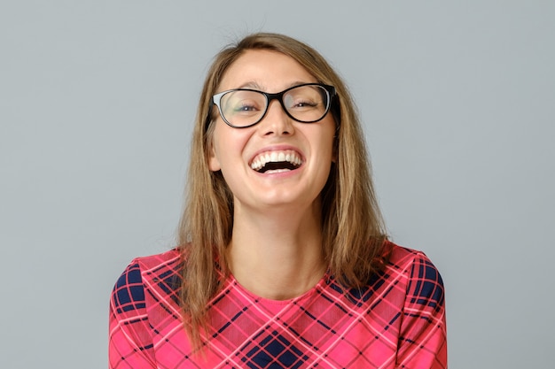 Portrait of young emotional beautiful woman laughing