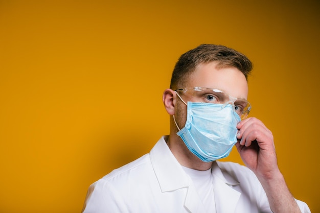 Portrait young exhausted doctor in blue medical mask on face