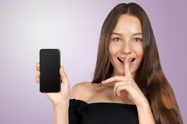 Portrait of a young fashionable woman holding a smartphone