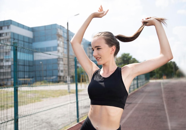 Portrait of a young female athlete in motion Outdoor sports activities