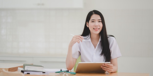 Portrait of young female doctor examining the patient chart and smiling to the camera 