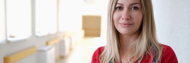 Portrait of young female doctor in red uniform in clinic