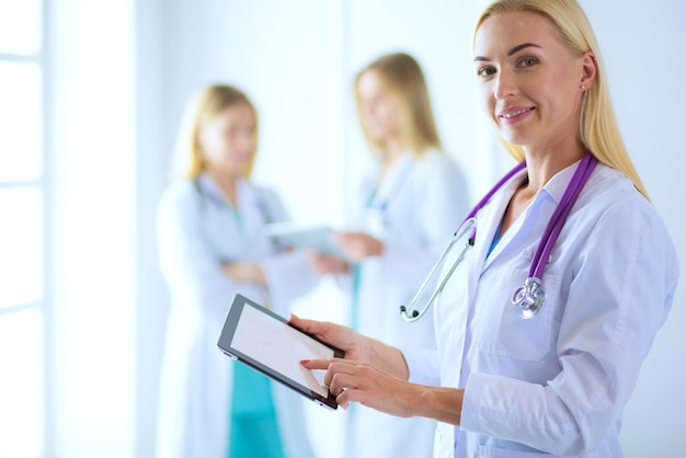 Portrait of a young female doctor with aipads in hand in a medical office