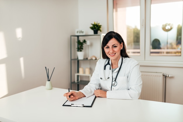 Portrait of a young female general practitioner in the medical office.